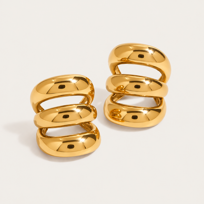 Two gold and silver two-tone triple-band ear cuffs, product shot for the Folie à Trois Unruly EAR CUFF.