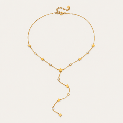 Gold Vagabonde Y NECKLACE with star and crystal stations and an adjustable clasp, shown fastened in a circle on a white background.