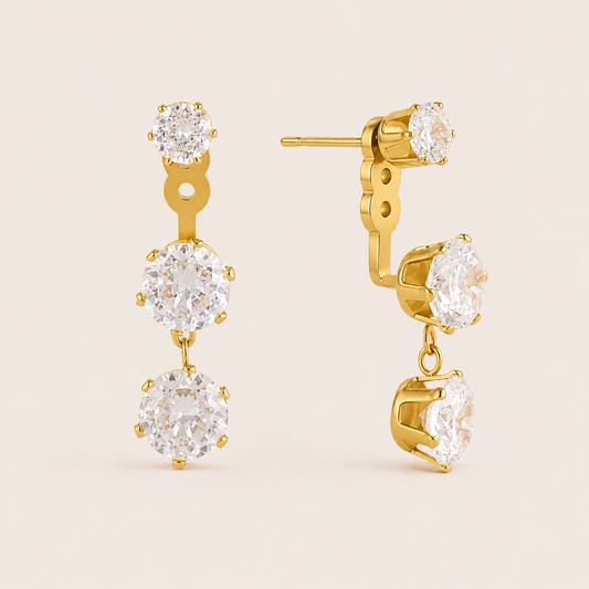 Gold Vega EARRINGS drops with three graduated round cubic zirconia stones in a vertical line, largest at the bottom.