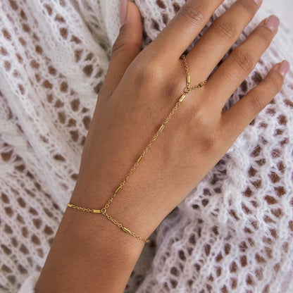 Venus Hand Chain BRACELET worn on the hand with a knit sweater in the background, delicate gold bar-station chain.