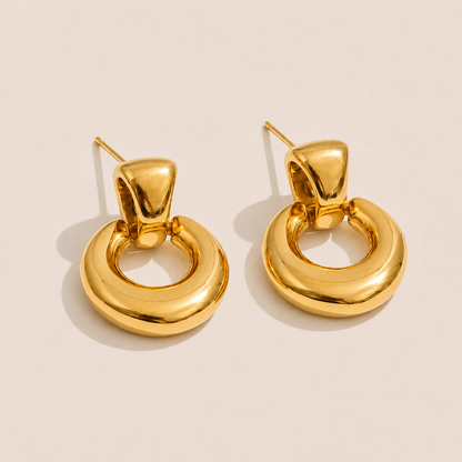 Gold chunky doorknocker earrings with a bold rounded hoop on a cream backdrop — Folie à Trois Verve EARRINGS