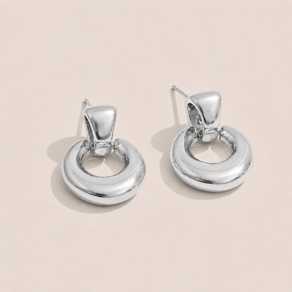 Silver chunky doorknocker earrings with a bold rounded hoop on a cream backdrop — Folie à Trois Verve EARRINGS