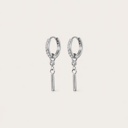Vibrant Hues Earrings pair a pave hoop with a dangling stick charm below a small clear stone, in silver tone.