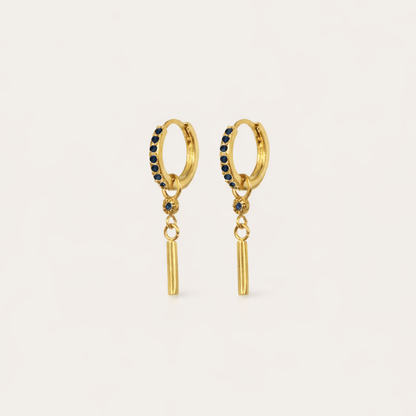 Vibrant Hues Earrings show a deep sapphire-blue pave hoop paired with a slim gold bar charm dangling beneath.