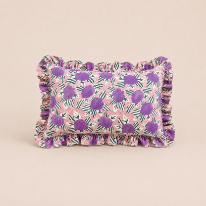 Violet Garden Rectangle cushion in pink with bold purple floral clusters and dark green leaves, finished with a ruffled edge.