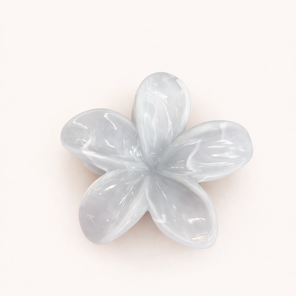 Virelle HAIR CLIP flower-shaped acetate claw clip in a pale ice-blue shade, studio shot.