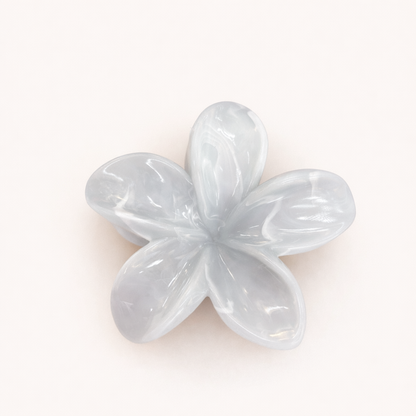 Virelle HAIR CLIP flower-shaped acetate claw clip in a pale ice-blue shade, studio shot.