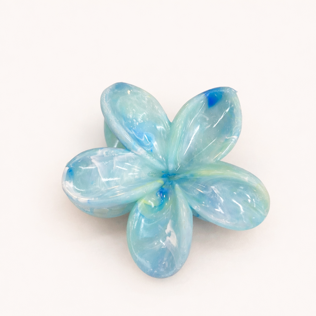 Virelle HAIR CLIP flower-shaped acetate claw clip in light blue with turquoise swirls, studio shot.
