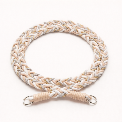 Beige, white, and gray braided Voyage long phone cord with gold thread, coiled flat with silver rings.