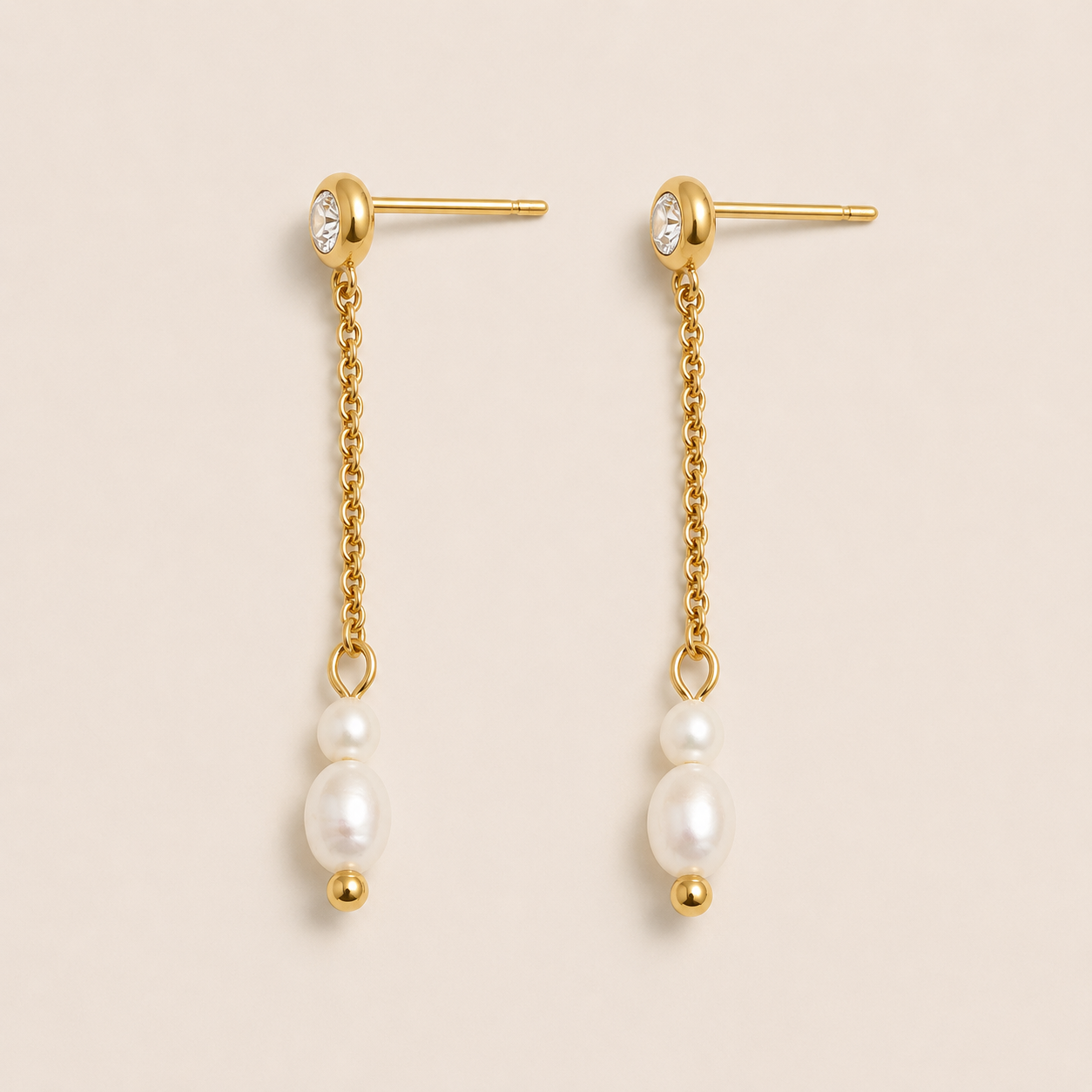 Gold drop earrings with a zirconia stud, fine chain and two freshwater pearls on a cream backdrop — Folie à Trois Whisper EARRINGS