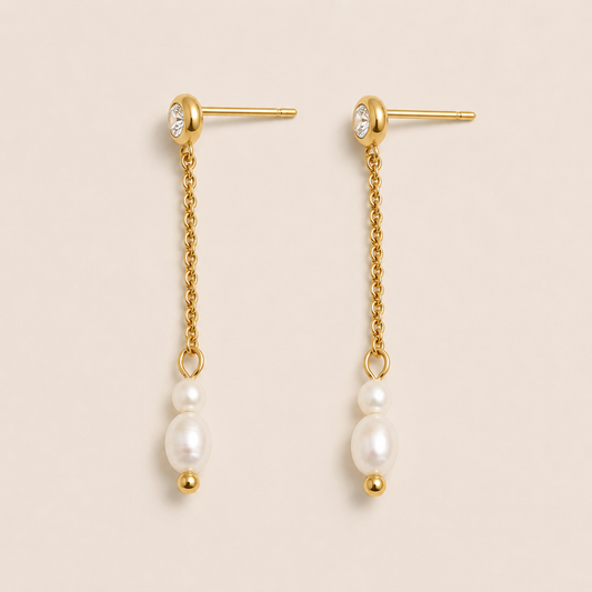 Gold drop earrings with a zirconia stud, fine chain and two freshwater pearls on a cream backdrop — Folie à Trois Whisper EARRINGS