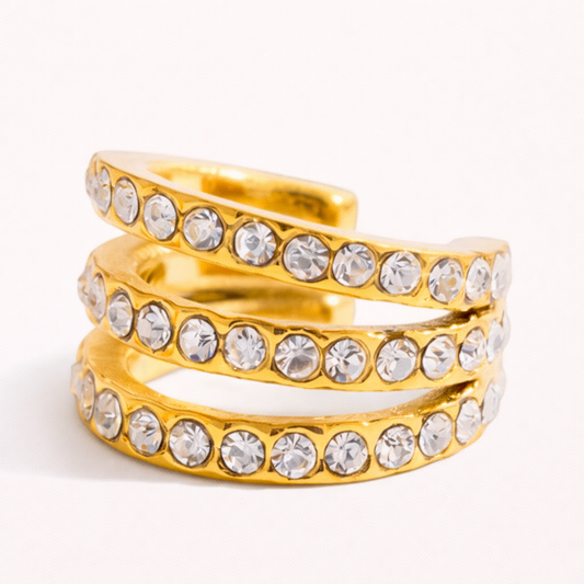 Wildcard Ear Cuff featuring three coiled rows of pave-set crystals in a spiral gold design, shown as a single cuff on a plain background.