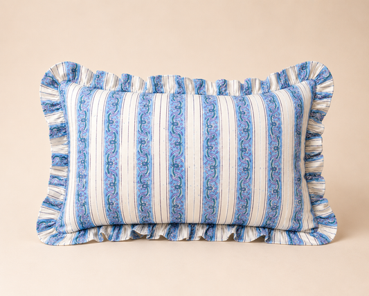 Blue and cream striped lumbar cushion with a paisley vine pattern and ruffled edge, the Yavi Blue Rectangle Cushion on a neutral backdrop.