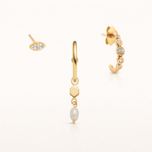 The You Ready SET in gold with clear stones and a pearl, featuring a two-stone stud, a pearl dangle hoop, and a pavé climber hoop in studio.