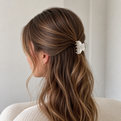Yumi HAIR CLIP in iridescent white, worn holding a half-up style on highlighted brunette hair.