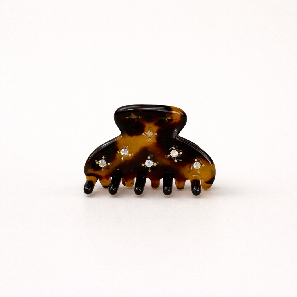 Yumi HAIR CLIP small acetate claw clip in dark tortoiseshell with crystal star accents, studio shot.