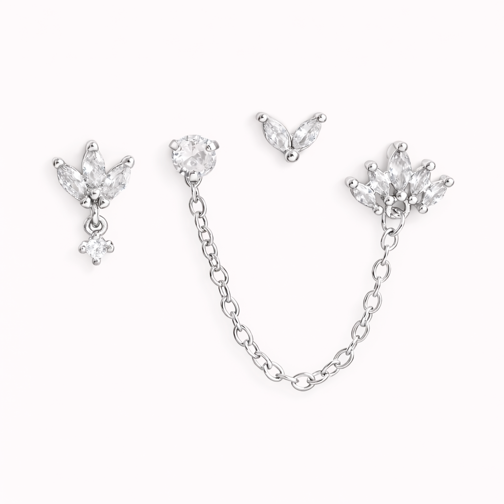 The Yvette SET is shown in silver: a leaf-cluster stud with drop, a chain stud, and a small petal charm.