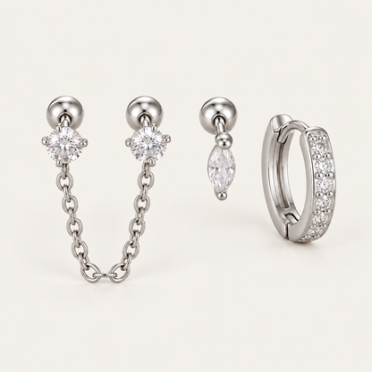 The Folie à Trois Zélie SET in silver: a chain-linked double stud, a marquise drop stud and a pavé huggie hoop.