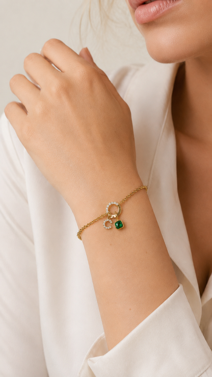 Zircon Charm BRACELET worn on the wrist with a green zircon charm dangling from the crystal circle clasp.