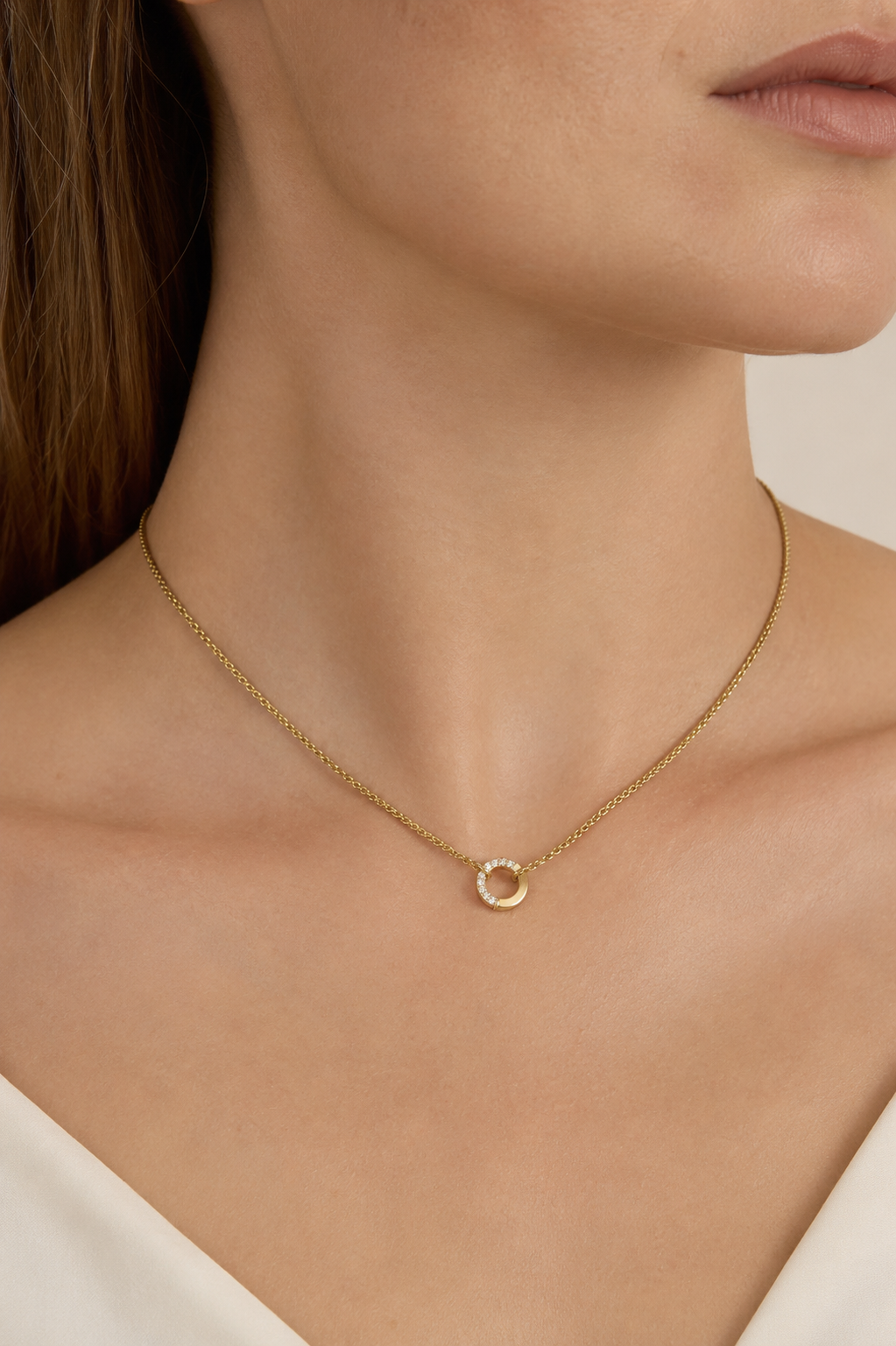 The Zircon Charm NECKLACE in a close neckline crop, the small pave zircon circle pendant catching the light with no charms.