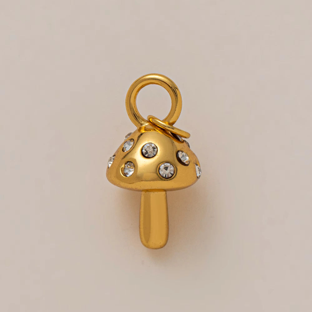 The Zircon Mushroom CHARM in gold, a mushroom-shaped pendant set with clear zircon stones, shown in close-up studio photography.