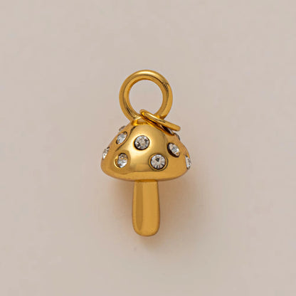 The Zircon Mushroom CHARM in gold, a mushroom-shaped pendant set with clear zircon stones, shown in close-up studio photography.