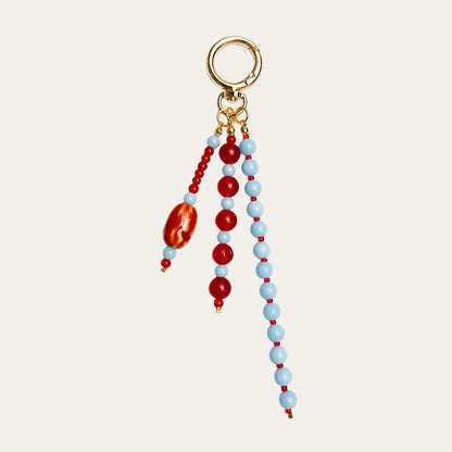 Isadora BAG CHARM Coral Sky - red and light blue beaded strands with red agate stone