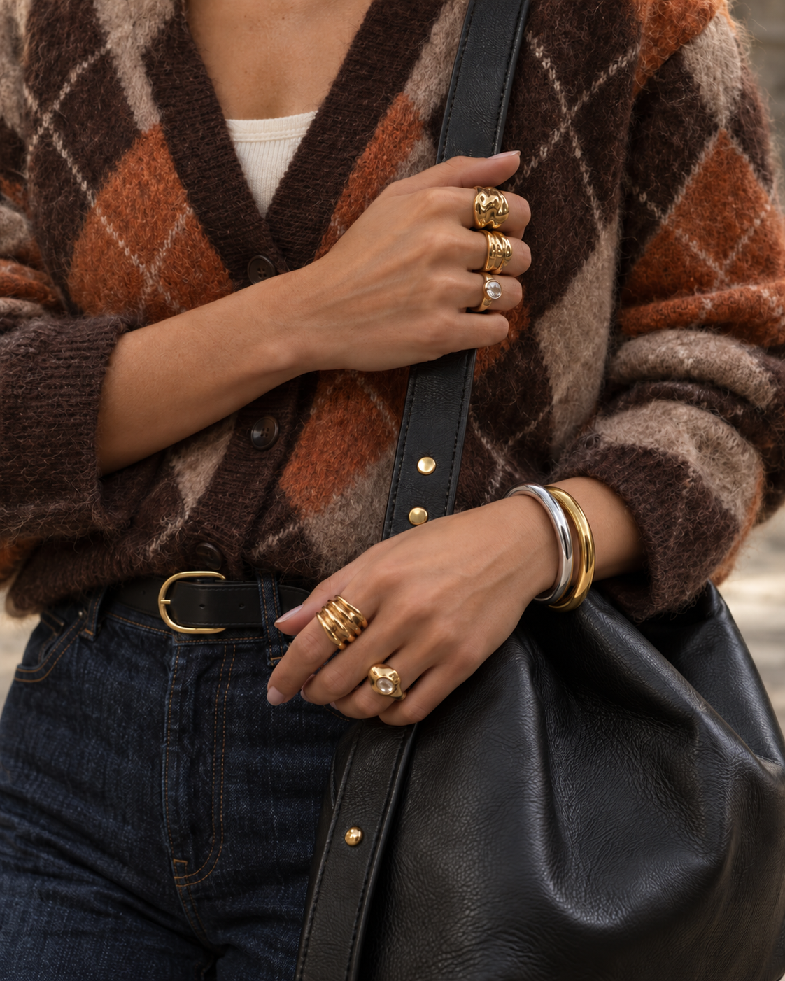 Woman in an argyle cardigan with gold rings and gold and silver-tone Arco BRACELETS stacked on her wrist — Folie à Trois wholesale