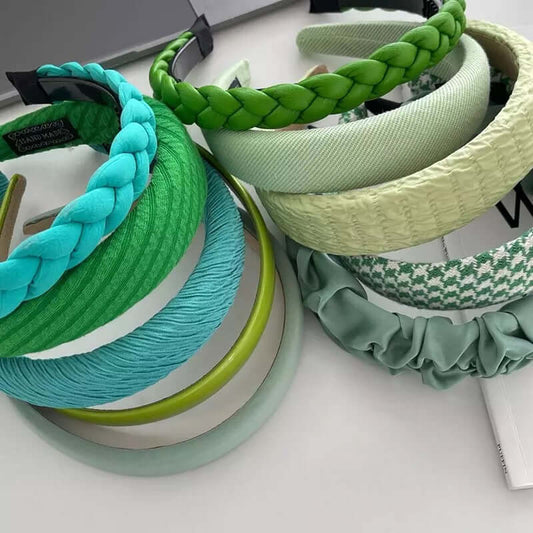 An assortment of green and teal headbands in braided, padded, ribbed and houndstooth styles - a generic catalog shot, not dedicated to Celena.