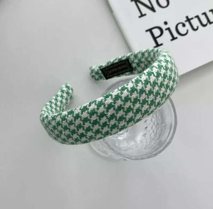 Green and white houndstooth padded headband styled on a glass tumbler, from a generic headband catalog set.