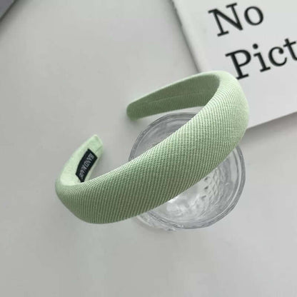 Mint green ribbed padded headband styled on a glass tumbler, from a generic headband catalog set.