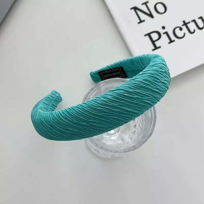 Teal ruched satin headband styled on a glass tumbler, from a generic headband catalog set.