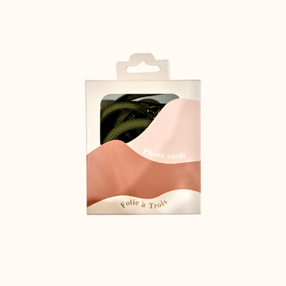 Colorful PHONE CORD packaging box showing an olive green cord coiled inside, by Folie à Trois.