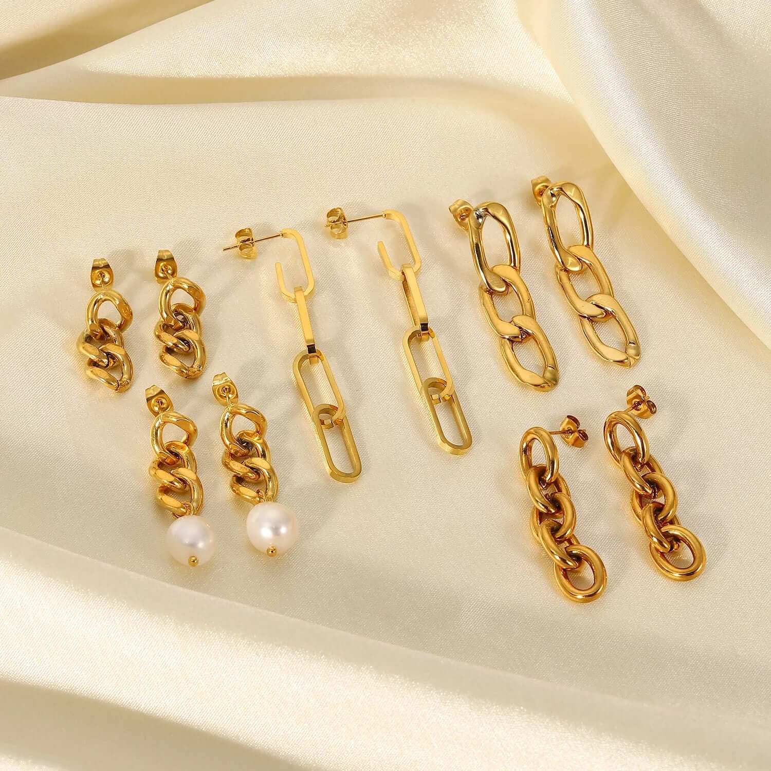 Another angle shows the Lotte Earrings collection, mixing curb chains, paperclip links, and pearl accents.