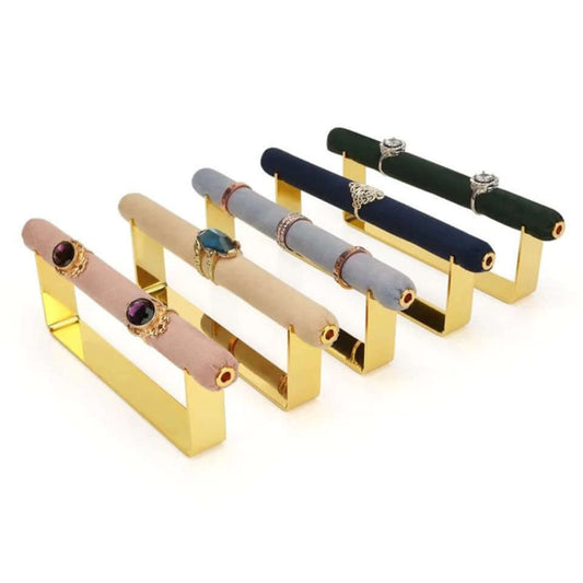 Velvet Ring DISPLAY stands in gold with velvet bars in mauve, tan, grey, navy, and green, several shown holding rings, arranged in a row.