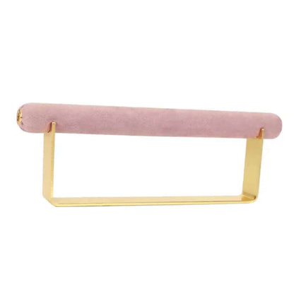 Velvet Ring DISPLAY stand in gold with a dusty pink velvet bar, shown empty at an angle against a white background.