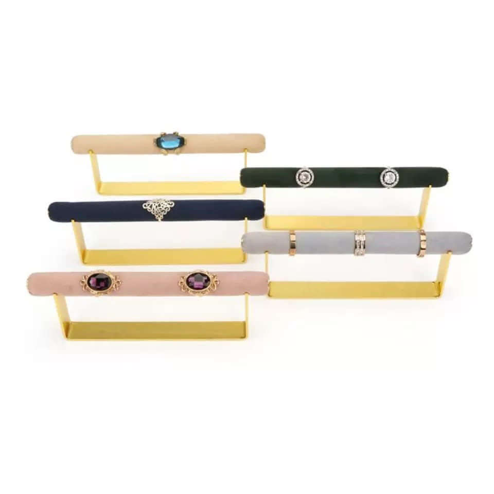 Velvet Ring DISPLAY stands in gold, tiered with rings on each velvet bar in tan, green, navy, grey, and mauve tones.